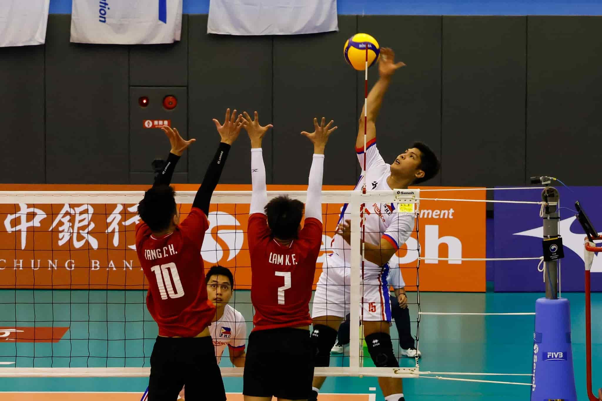Marck Espejo of the Philippines facing two blockers of Macau in the 2023 AVC Challenge Cup for Men