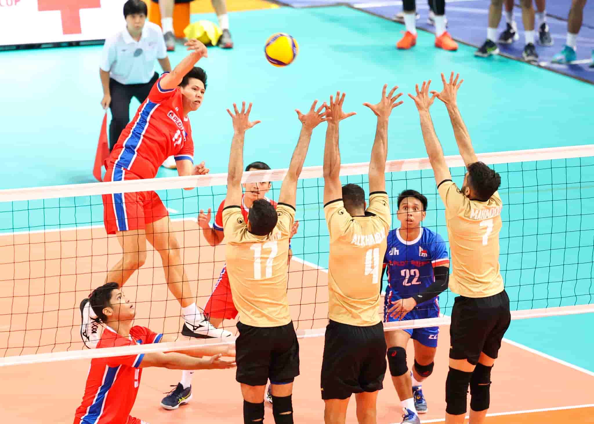 Philippines' Joshua Umandal against Bahrain's three blockers in their match