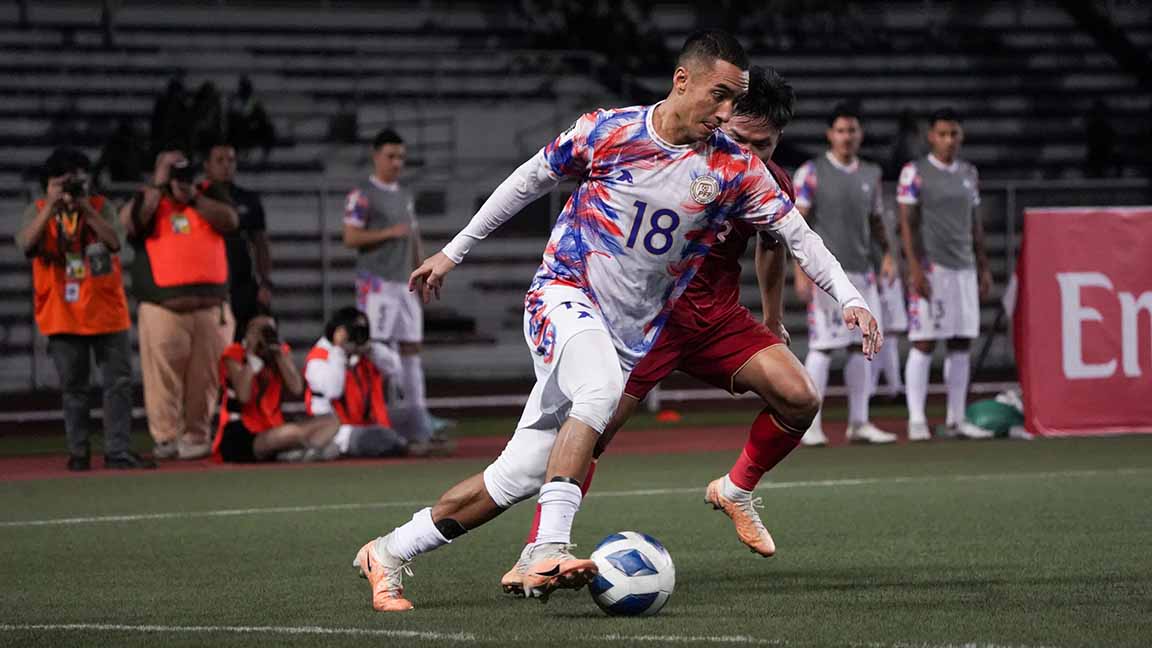 Patrick Reichelt against an Indonesian defender