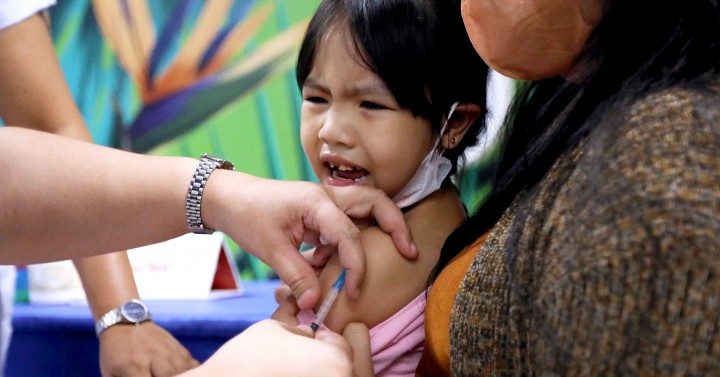 A kid having a vaccine shot.