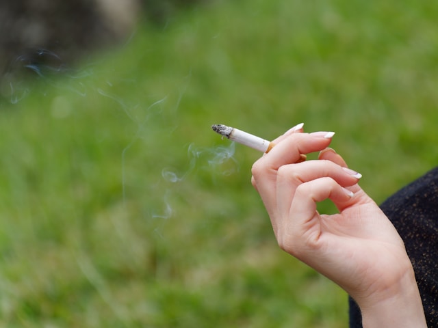 A hand holding a cigarette.