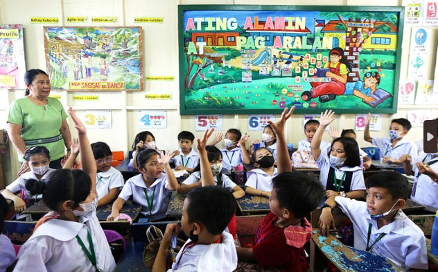 Students and their teacher inside a classroom.