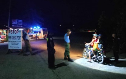 Police personnel man the checkpoint in La Castellana, the locality worst hit by the eruption of Mt. Kanlaon